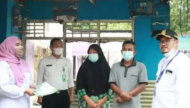 1647921324_871x497_copy_653x373 Sekretaris Kecamatan Legok, Kabupaten Tangerang, Farid Ma'arup, saat menyerahkan dokumen Administrasi Penduduk (Adminduk) untuk keluarga Supandi.